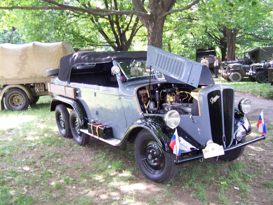 pale blue limousine with right lid of hood lifted