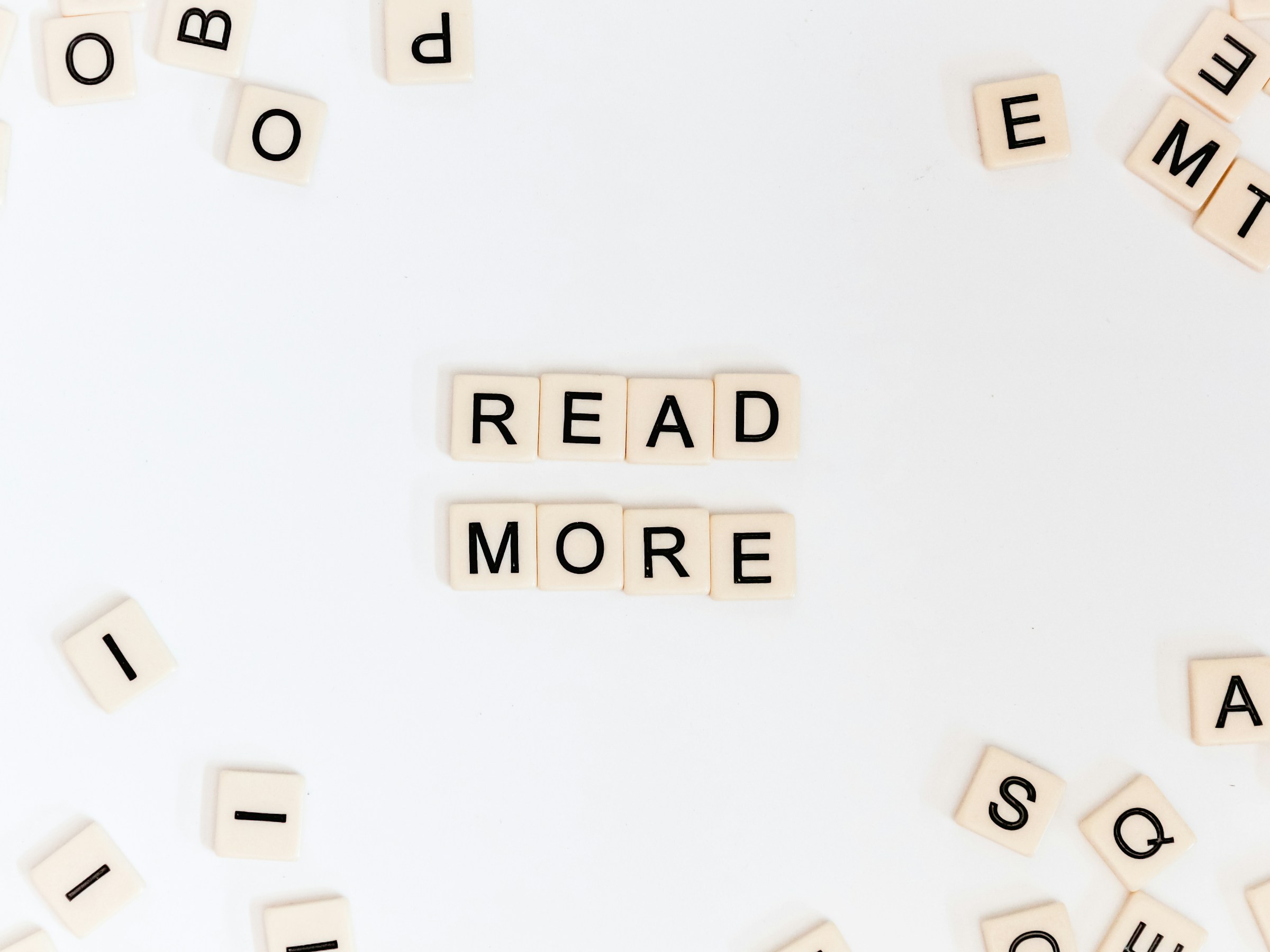 scrabble pieces forming the words 'read more'
