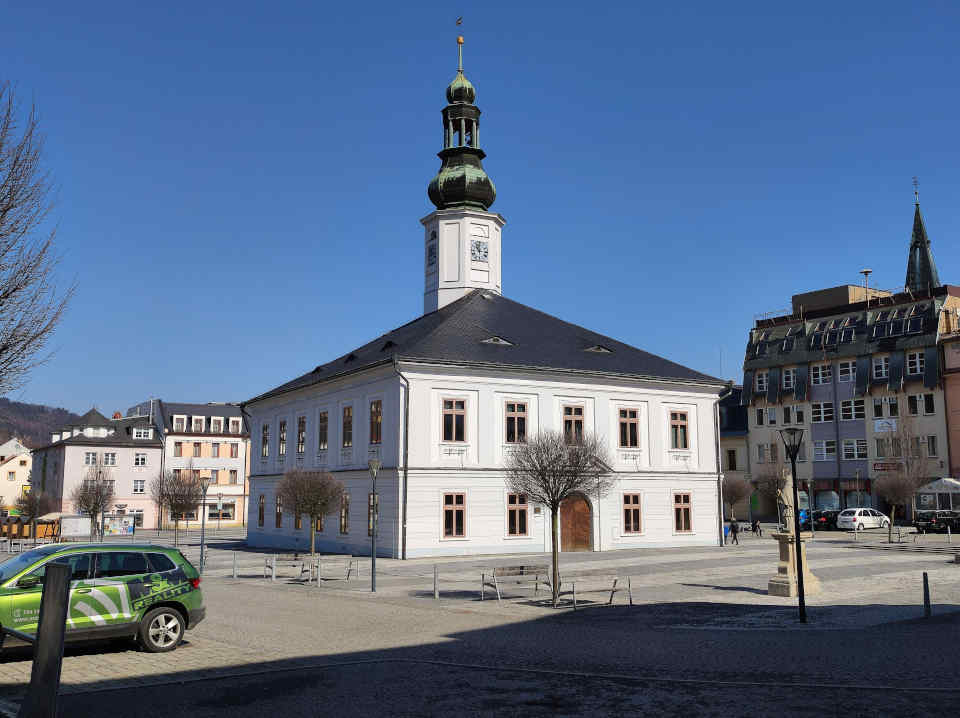 white two-story rectangular building with bell tower